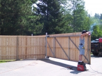 Sliding wooden gate with a steel frame